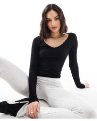 Stradivarius - Top Van Jersey Met V-Hals En Lange Mouwen - Lyst