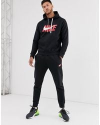 Nike Synthetik Schwarzer gewebter Trainingsanzug im Set Nike Synthetik Schwarzer gewebter Trainingsanzug im Set