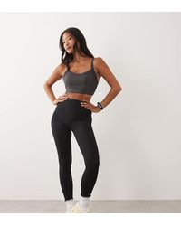4505 - Leggings Deportivos Negros De Talle Alto Con Bolsillo Interior Y Diseño Moldeador En La Parte Trasera Icon De Petite - Lyst