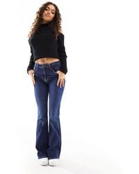 Bershka - Petite - jeans a zampa a vita alta lavaggio indaco - Lyst