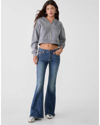Stradivarius - – d04 – schlagjeans mit niedrigem bund, weitem bein und mittlerer denim-waschung - Lyst