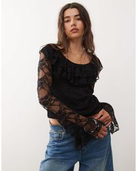 Reclaimed (vintage) - Top en dentelle avec manches anges longues et encolure à volants - noir - Lyst