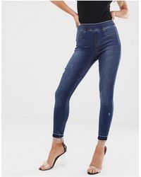 Spanx - Shape And Lift Distressed Skinny Jeans - Lyst