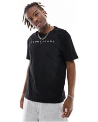 Tommy Hilfiger - T-shirt regular fit nera con logo lineare - Lyst