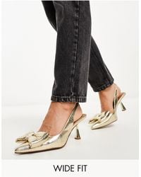 ASOS - Wide fit - scarlett - scarpe con tacco medio dorate con fiocco a pianta larga - Lyst