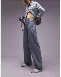 TOPSHOP - Jeans con cinturino sul retro effetto candeggiato sporco - Lyst
