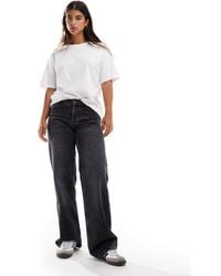 TOPSHOP - Hourglass – ember – jeans mit niedrigem bund, weitem bein und er dirty-waschung - Lyst