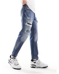 ASOS - Jeans classici rigidi lavaggio medio con strappi - Lyst