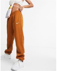 Nike Joggers extragrandes en marrón anaranjado Swoosh