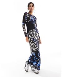 Vero Moda - Robe longue en tulle imprimé papillons abstrait avec bords ondulés et manches longues - Lyst