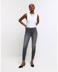 River Island - High Waisted Bum Sculpt Ripped jeggings - Lyst