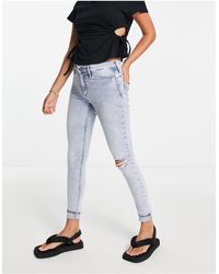 River Island - Molly - jeans skinny modellanti azzurri con strappo - Lyst