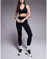 4505 - Hourglass Icon Active Tie Waist Run legging With Phone Pocket - Lyst