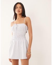 The Frolic - Exclusive Poplin Look Shirred Tie Front Cami Flippy Hem Mini Dress - Lyst