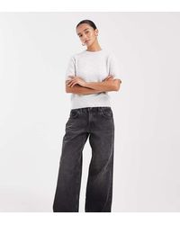 ASOS - Vaqueros Negro Lavado De Talle Bajo Y Corte Holgado De Asos Design Petite - Lyst