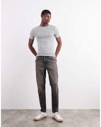 ASOS - Tapered Fit Jeans With Yellow Tint - Lyst