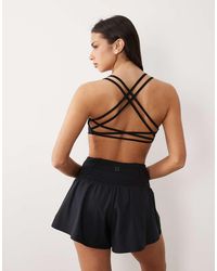 4505 - Light Support Strappy Sports Bra - Lyst