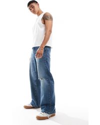 ASOS - Jeans larghi con fondo ampio lavaggio medio - Lyst