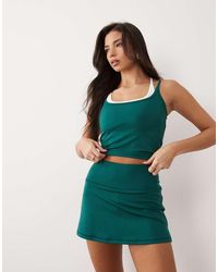 4505 - Active Tennis Skirt With Under Shorts And Phone Pocket - Lyst