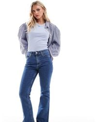 ASOS - Asos Design Petite Mid Rise Flare Jeans - Lyst