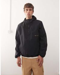 Champion - Giacca Nera Con Zip Corta E Cappuccio - Lyst