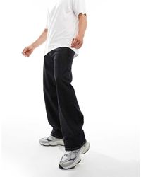 Weekday - Vaqueros Negros Sueltos De Talle Bajo Con Lavado Ácido Sphere De - Lyst