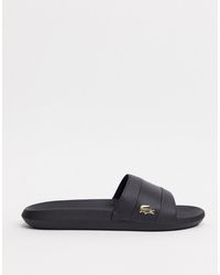 lacoste gold croc sliders in black