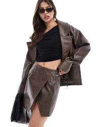 SNDY'S - Leather Look Wrap Buckle Side Mini Skirt Co-ord - Lyst