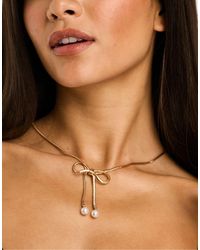 True Decadence - Bow Necklace With Faux Pearls - Lyst