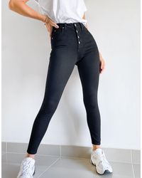 Calvin Klein – Enge Jeans mit hoher Taille und sichtbaren Knöpfen - Schwarz