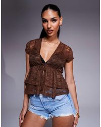 ASOS - Top en dentelle transparente style festival avec liens noués devant et volants - Lyst