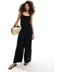ASOS - Jumpsuit Met Wijde Pijpen En Lage Ronde Hals - Lyst
