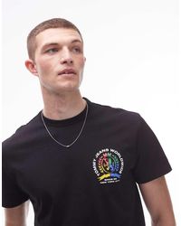 Tommy Hilfiger - Camiseta Negra Con Estampado Gráfico Trasero Del Logo De Escudo De Colores De - Lyst