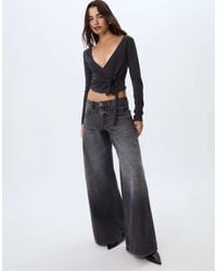 Stradivarius - Jeans A Fondo Ampio E Vita Bassa Neri Effetto Slavato Con Stelle - Lyst