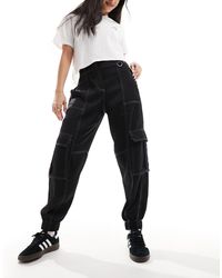 AllSaints - Fran - pantaloni neri con polsini - Lyst