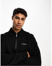 Calvin Klein - Sudadera negra con media cremallera y logo pequeño - Lyst