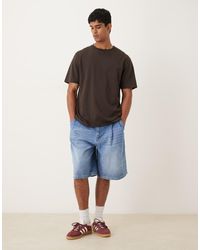 ASOS - Pantalones Cortos Vaqueros De Corte Alargado Con Lavado Crudo Y Pinzas Dobles De -Azul - Lyst