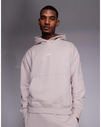 HUGO - Sweat à capuche d'ensemble ample en coton avec logo imprimé au dos - clair - Lyst