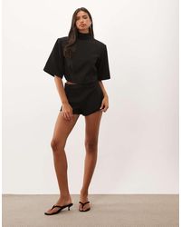Missy Empire - Missy Empire High Neck Batwing Sleeve Open Back Top - Lyst