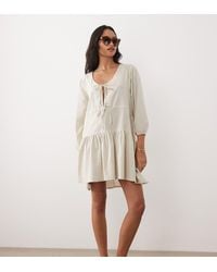 esmé studios - Esmee Linen Mix Long Sleeve Tiered Mini Tie Front Beach Dress - Lyst