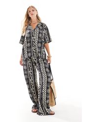 ASOS - Pantalon d'ensemble ample à imprimé coquillages - noir et blanc - Lyst
