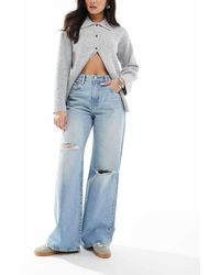 Calvin Klein - Vaqueros Azul Claro Tintado De Pernera Ancha Con Diseño Rasgado De - Lyst