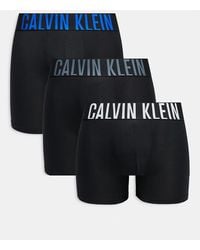 Calvin Klein - Pack De 3 Calzoncillos Bóxer Negros Con Cinturillas De Color Gris Y Azul Con Logo De Microfibra Intense Power De - Lyst