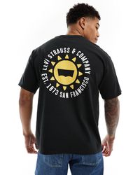 Levi's - T-shirt nera con stampa di sole e logo al centro e sul retro - Lyst