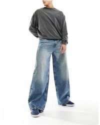 Collusion - X013 - jeans con fondo ampio a vita medio alta lavaggio medio - Lyst