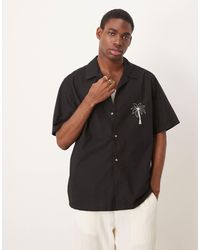 ASOS - Chemise décontractée avec col à revers et imprimé palmier sur la poitrine et dans le dos - Lyst