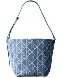 Calvin Klein - Denim Bucket Bag With Allover Emblem Print - Lyst
