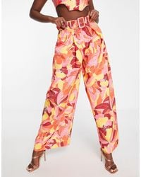 ASOS - Pantaloni a pieghe a fondo ampio con stampa vivace a fiori e cintura - Lyst