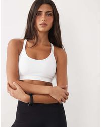 4505 - Seamless Cross Backs Medium Support Sports Bra With Adjustable Straps - Lyst