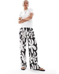 Vero Moda - – plissee-hose mit hohem bund, weitem bein und tropischem blumenmuster - Lyst